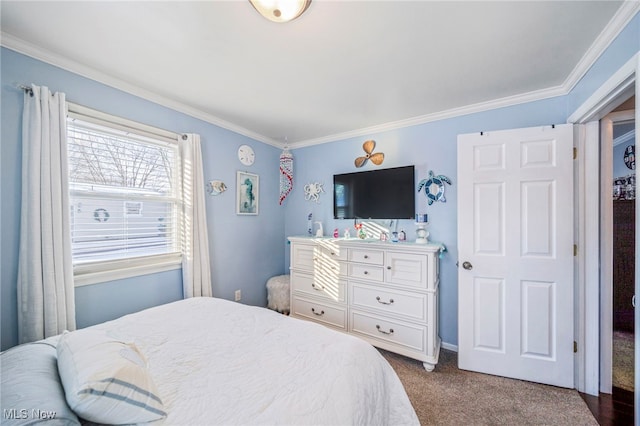 bedroom with ornamental molding and carpet floors