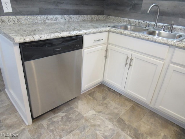 kitchen featuring white cabinetry, stainless steel dishwasher, light stone countertops, and sink