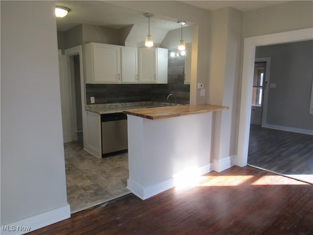 kitchen with wooden counters, white cabinetry, decorative light fixtures, stainless steel dishwasher, and kitchen peninsula