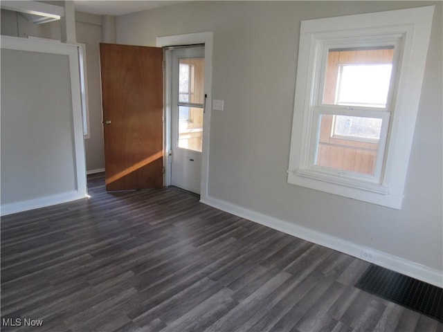 unfurnished room with dark hardwood / wood-style floors