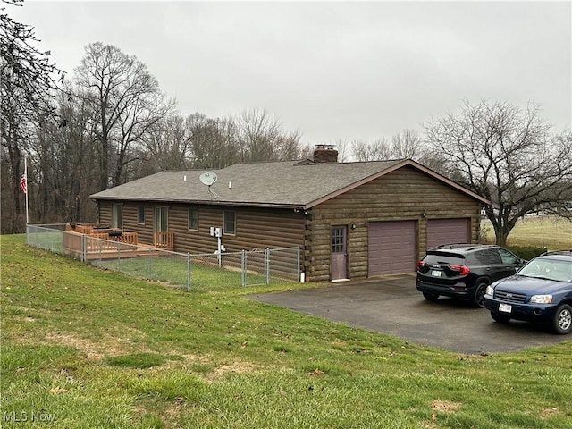 view of front of home with a garage and a front yard