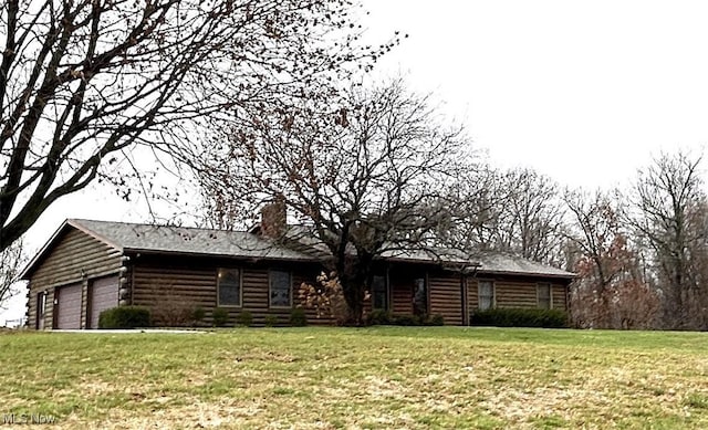 log home with a garage and a front yard