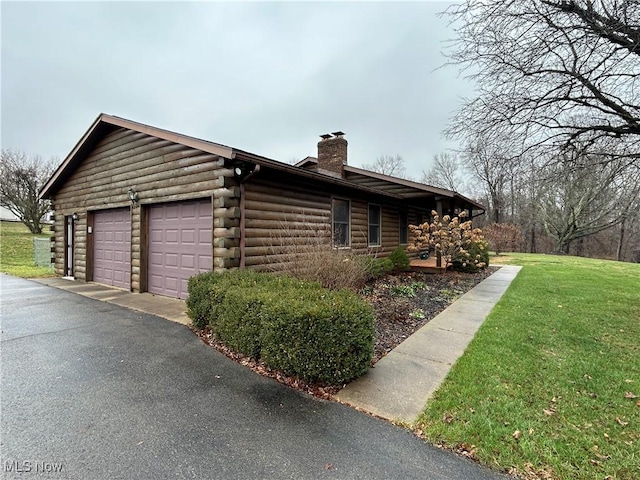 view of property exterior featuring a garage and a lawn