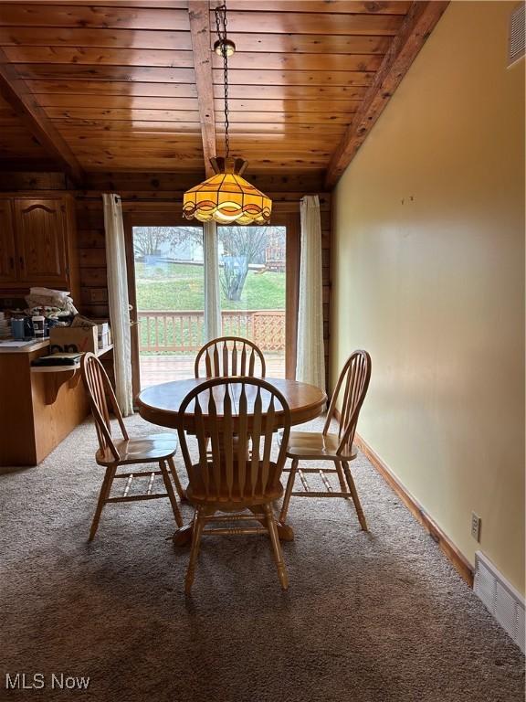 dining area with lofted ceiling, carpet floors, and wooden ceiling