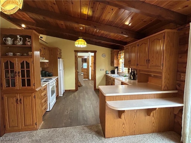 kitchen featuring sink, a kitchen breakfast bar, hanging light fixtures, kitchen peninsula, and white appliances