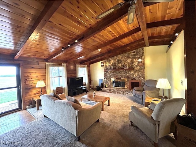 living room featuring a fireplace, lofted ceiling with beams, carpet flooring, ceiling fan, and wooden ceiling