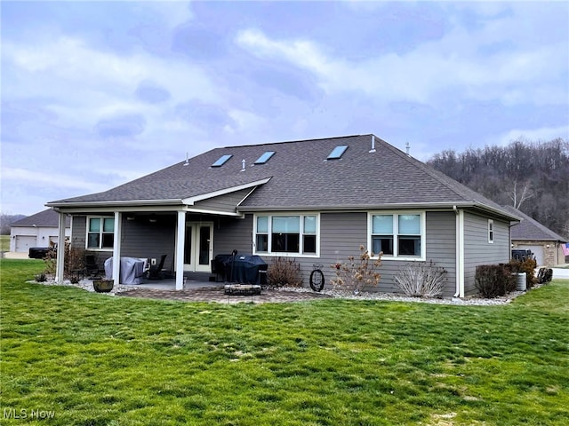 rear view of house featuring a patio and a yard