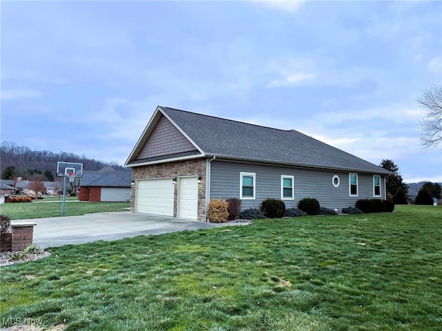 view of side of property with a garage and a yard