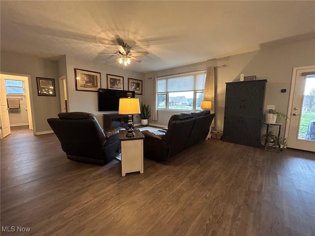 living room featuring dark hardwood / wood-style flooring and ceiling fan