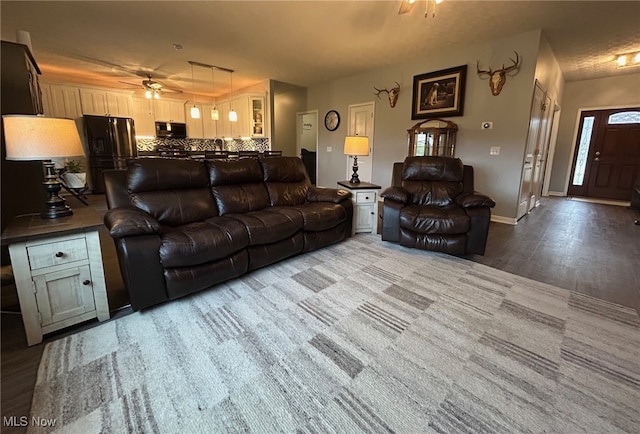 living room featuring hardwood / wood-style flooring and ceiling fan