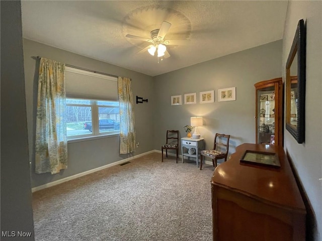 sitting room with carpet flooring and ceiling fan