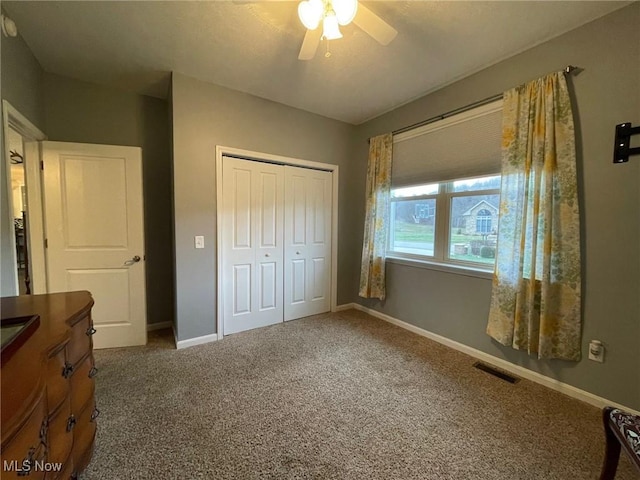 unfurnished bedroom featuring carpet, ceiling fan, and a closet