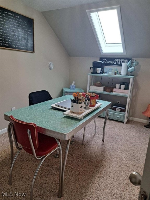 office space with lofted ceiling with skylight and carpet