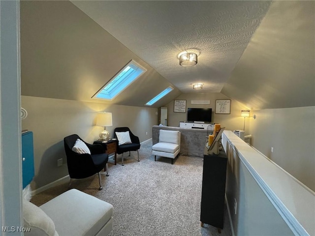 interior space with lofted ceiling with skylight, light carpet, and a textured ceiling