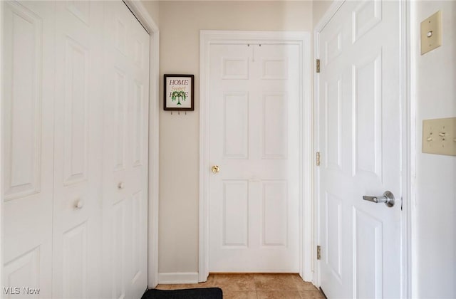 hall featuring light tile patterned floors