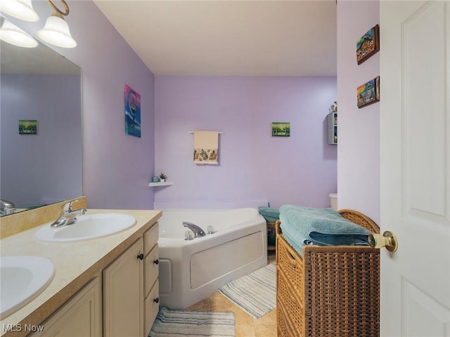 bathroom with tile patterned flooring, vanity, and a tub