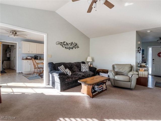 carpeted living room with ceiling fan and lofted ceiling