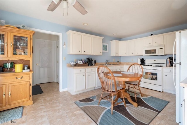 kitchen with ceiling fan, sink, light tile patterned floors, and white appliances