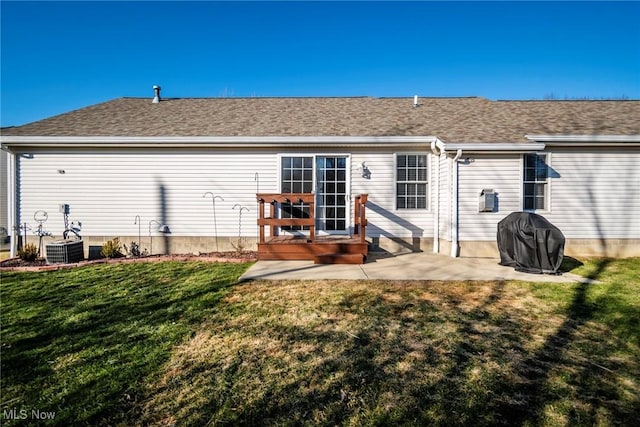 back of property with a patio, central AC, and a lawn