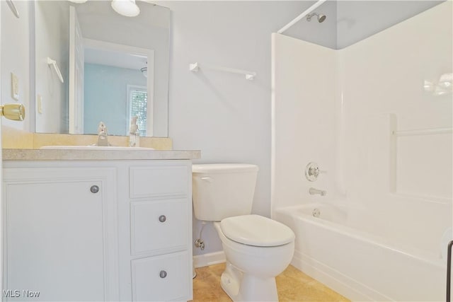 9278 Woodworth Rd Unit 1801, North Lima, OH 44452 - bathroom featuring toilet, vanity, tub / shower combination, tile patterned floors, and baseboards
