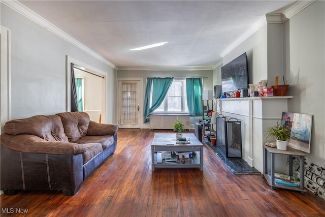 living room featuring ornamental molding and dark hardwood / wood-style floors