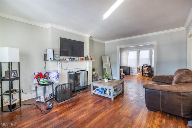 living room with crown molding and hardwood / wood-style flooring