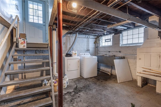 basement featuring separate washer and dryer and sink