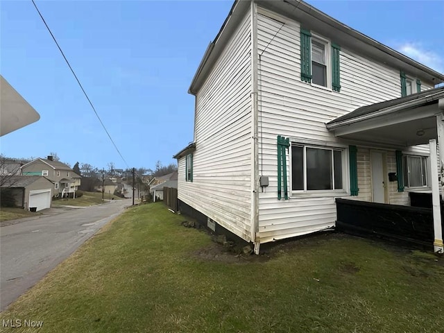 view of side of property with a lawn