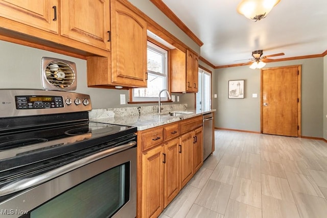 kitchen with crown molding, appliances with stainless steel finishes, light stone countertops, and sink