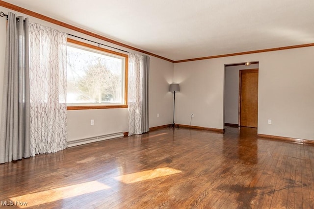 spare room with crown molding, a baseboard heating unit, and dark hardwood / wood-style flooring