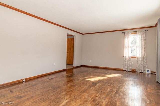 spare room with crown molding and hardwood / wood-style floors