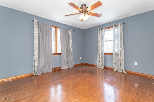 empty room with hardwood / wood-style floors and ceiling fan