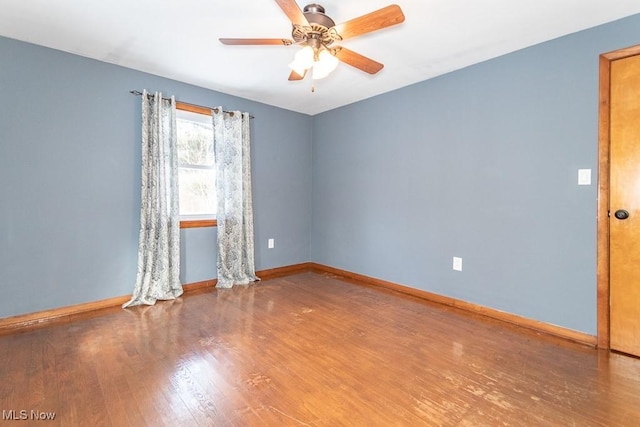 empty room featuring hardwood / wood-style flooring and ceiling fan