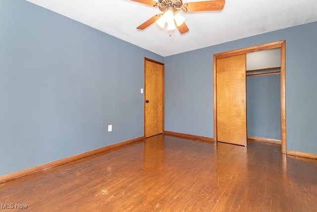 unfurnished bedroom with hardwood / wood-style flooring, a closet, and ceiling fan