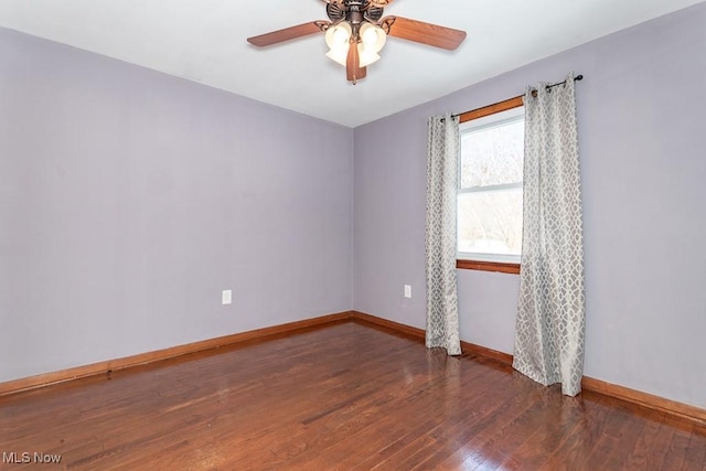 empty room featuring dark hardwood / wood-style floors and ceiling fan