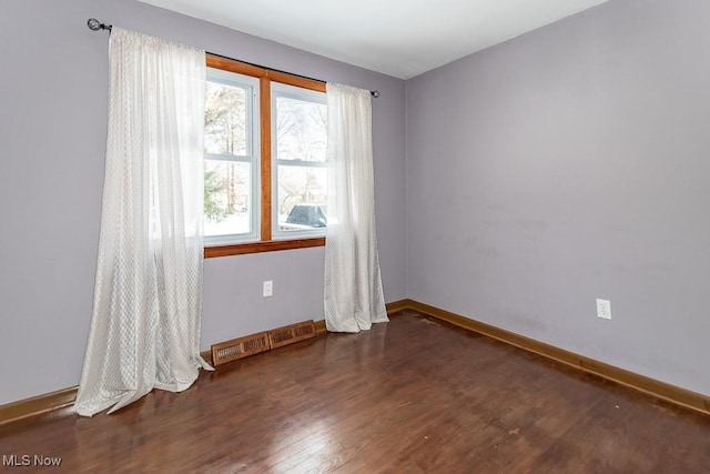 unfurnished room featuring dark wood-type flooring