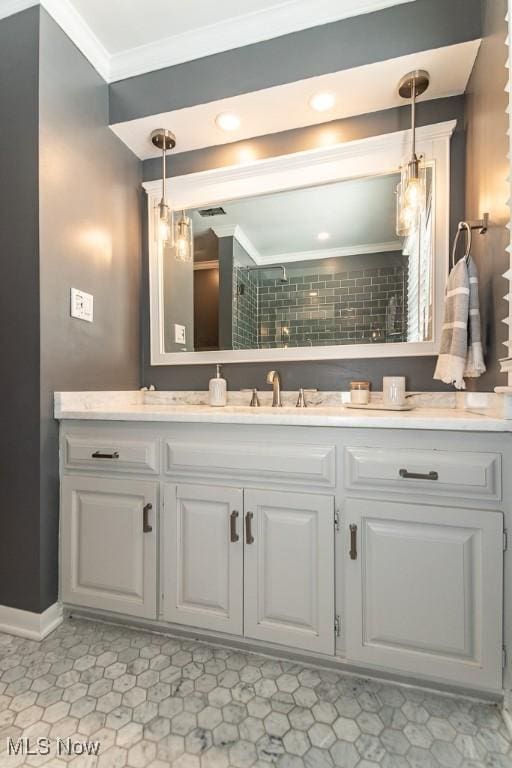 bathroom featuring ornamental molding and vanity