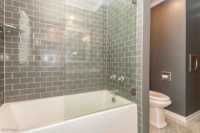 bathroom featuring tiled shower / bath combo, tile patterned floors, and toilet