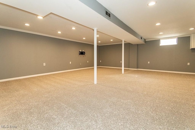 basement with crown molding and carpet floors