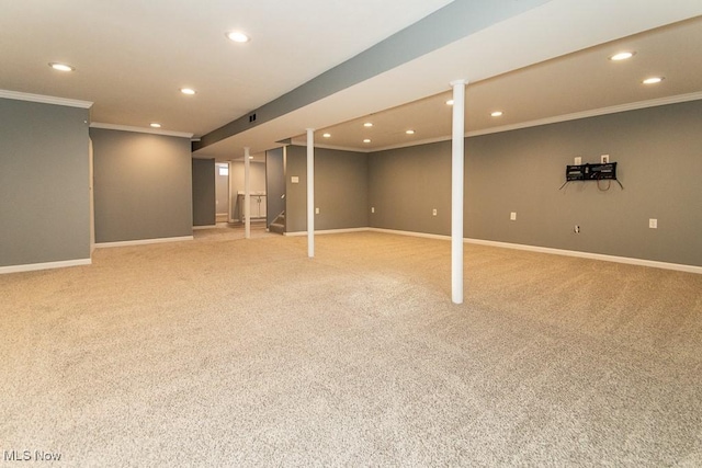 basement with light colored carpet and ornamental molding