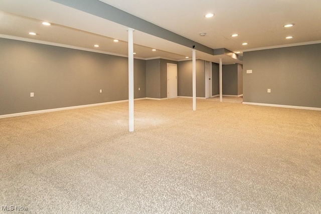 basement featuring ornamental molding and carpet floors