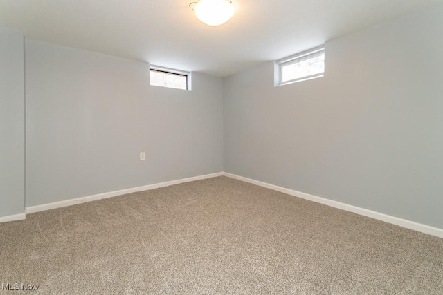 basement featuring plenty of natural light and carpet