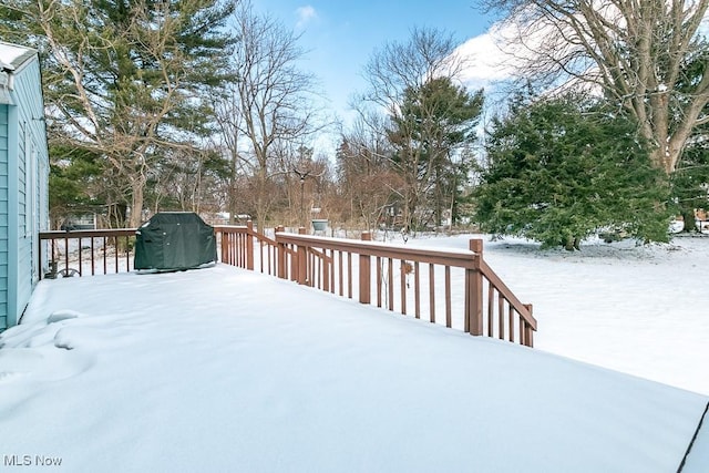 snow covered deck featuring a grill