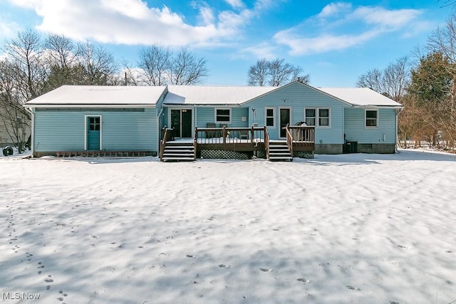 snow covered house featuring a deck