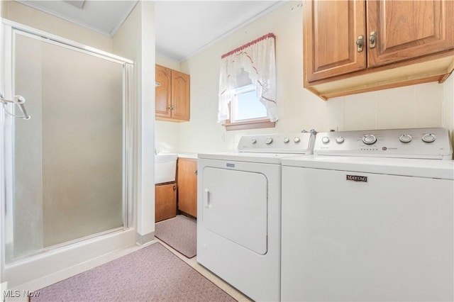 laundry room featuring cabinets and washing machine and clothes dryer