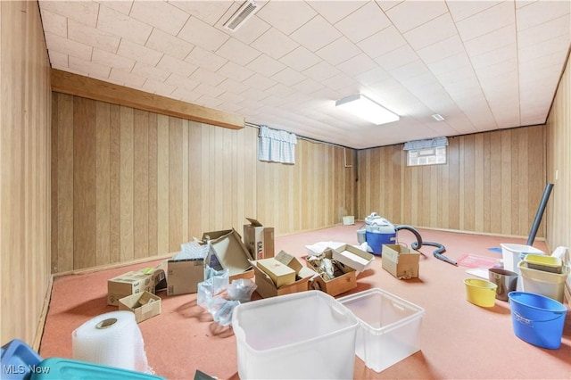 recreation room with carpet flooring and wood walls