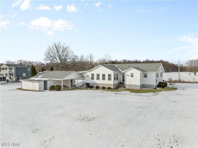 view of front of property featuring a shed