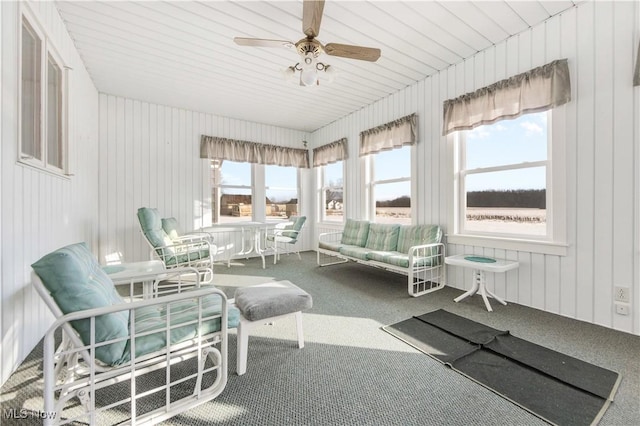 sunroom / solarium featuring plenty of natural light and ceiling fan