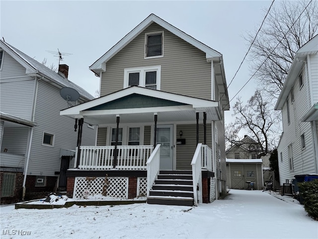 view of front of house featuring a storage shed and a porch