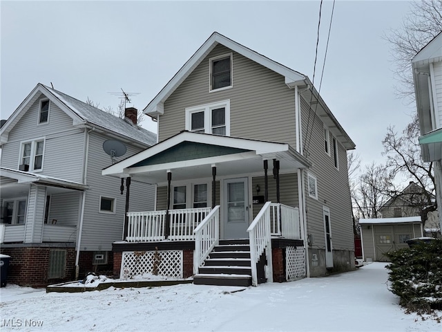 view of front of home with a storage shed and covered porch